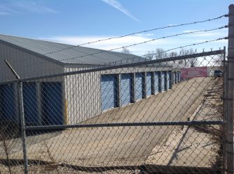 fence in front of a storage garage